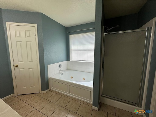 bathroom featuring tile patterned floors and separate shower and tub