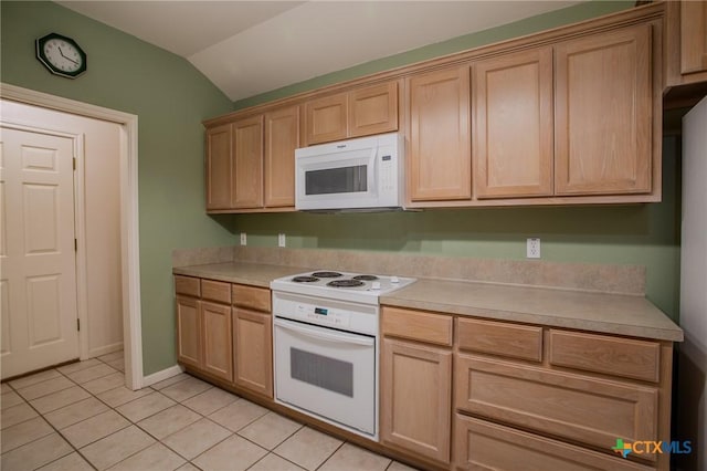 106 Fieldstone, Victoria, TX 77901 - kitchen with white appliances, vaulted ceiling, light tile patterned flooring, light countertops, and light brown cabinets