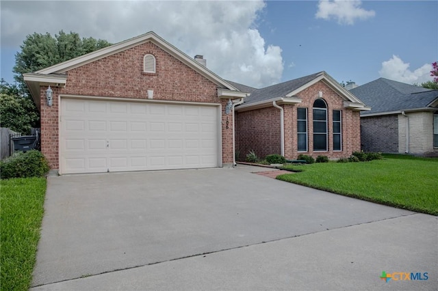 106 Fieldstone, Victoria, TX 77901 - single story home with brick siding, concrete driveway, a chimney, and a front lawn