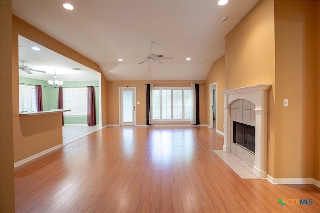 106 Fieldstone, Victoria, TX 77901 - unfurnished living room featuring a ceiling fan, plenty of natural light, a tile fireplace, light wood finished floors, and recessed lighting