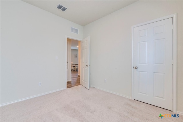 unfurnished bedroom with light colored carpet