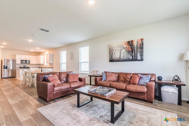 living room with light hardwood / wood-style floors