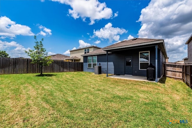 rear view of property with a patio and a yard