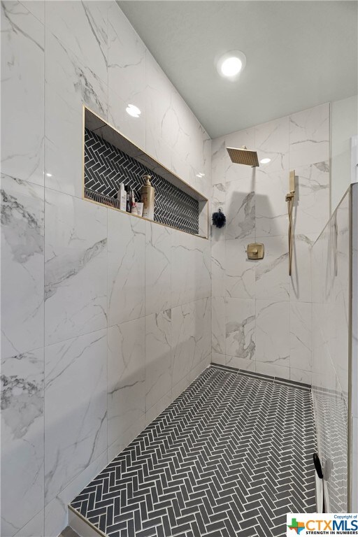 bathroom with tiled shower