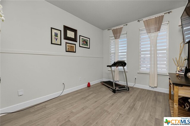 exercise area with light wood-type flooring