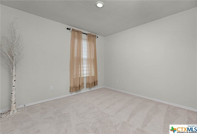 empty room with light colored carpet