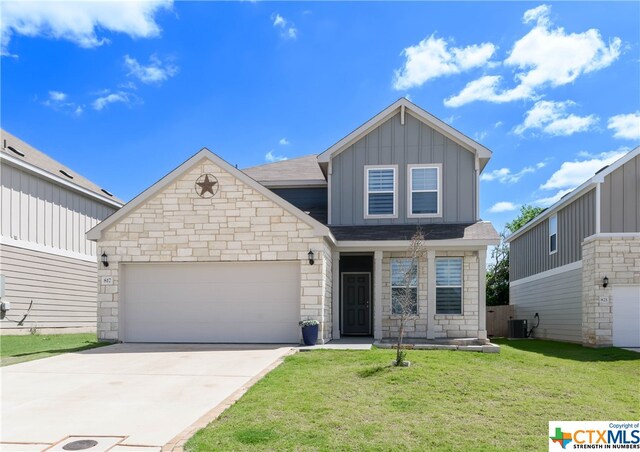 craftsman-style home with central AC unit, a front yard, and a garage