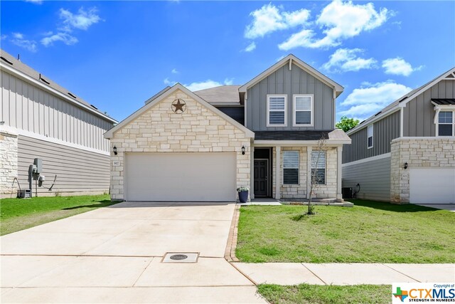 view of front of house with a garage and a front lawn