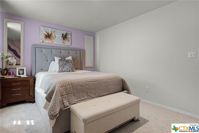 bedroom featuring light carpet