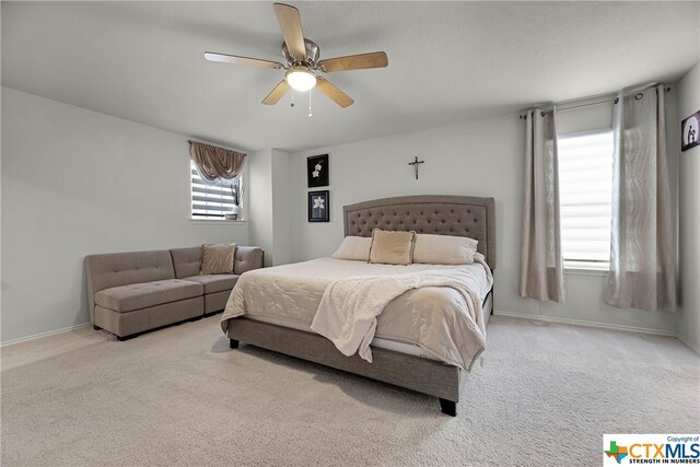 bedroom featuring light carpet and ceiling fan