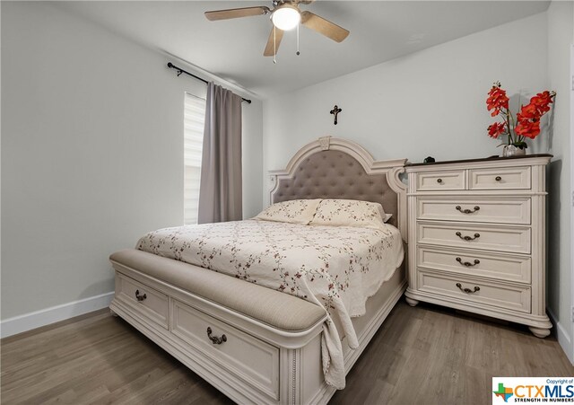 bedroom with hardwood / wood-style floors and ceiling fan