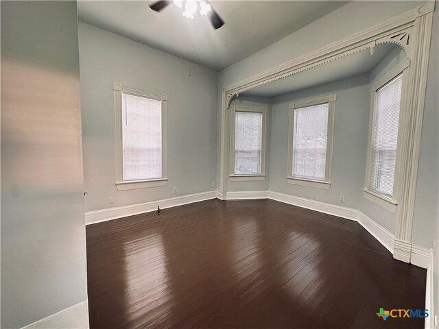 207 Schrimsher St, Yoakum, TX 77995 - spare room featuring dark wood-type flooring and ceiling fan