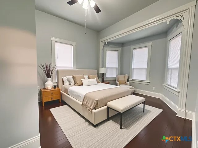 207 Schrimsher St, Yoakum, TX 77995 - bedroom with dark wood-style floors and ceiling fan