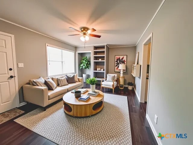 207 Schrimsher St, Yoakum, TX 77995 - living room with a ceiling fan, dark wood-style floors, and crown molding