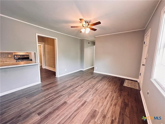 207 Schrimsher St, Yoakum, TX 77995 - unfurnished living room featuring ceiling fan, dark wood-style flooring, and crown molding