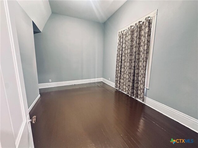 207 Schrimsher St, Yoakum, TX 77995 - empty room featuring baseboards and wood finished floors