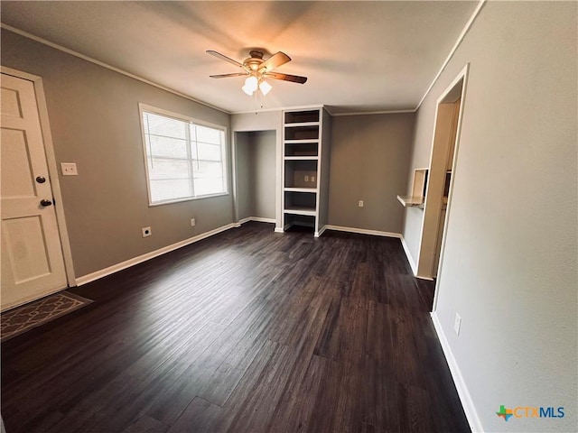 207 Schrimsher St, Yoakum, TX 77995 - unfurnished bedroom featuring dark wood finished floors, crown molding, and ceiling fan