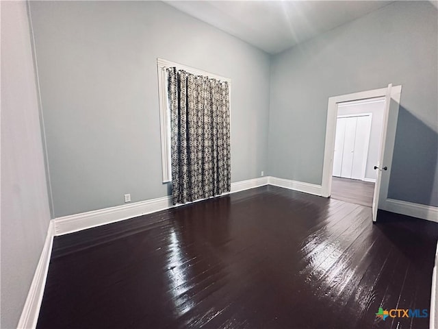 207 Schrimsher St, Yoakum, TX 77995 - empty room featuring dark wood-style floors and baseboards