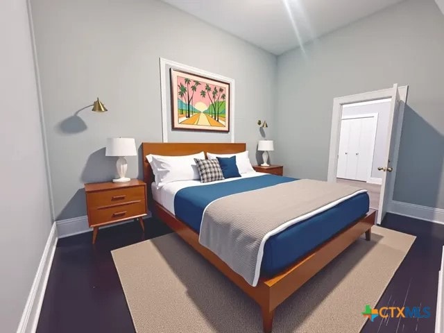 207 Schrimsher St, Yoakum, TX 77995 - bedroom featuring dark wood-type flooring