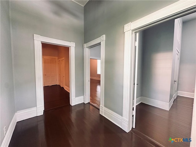 207 Schrimsher St, Yoakum, TX 77995 - hallway featuring dark wood-style floors and baseboards