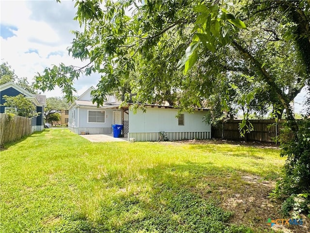 207 Schrimsher St, Yoakum, TX 77995 - fenced backyard with a patio area