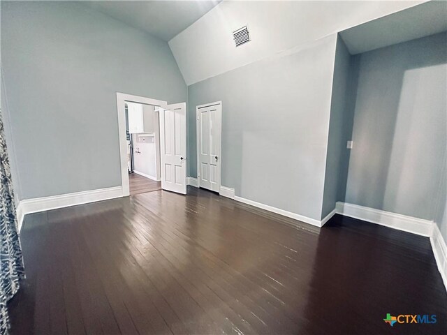 207 Schrimsher St, Yoakum, TX 77995 - empty room featuring wood-type flooring and vaulted ceiling