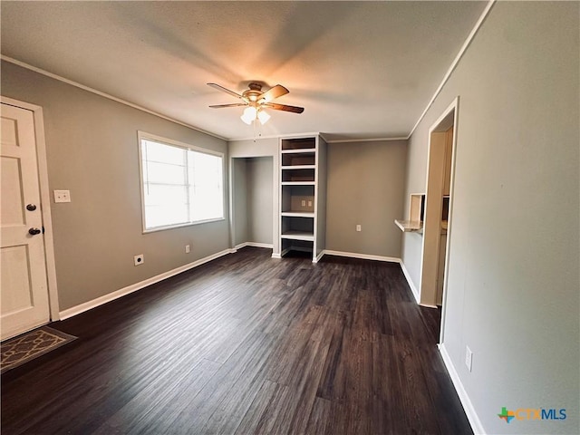 207 Schrimsher St, Yoakum, TX 77995 - unfurnished bedroom featuring dark wood-style floors and a ceiling fan