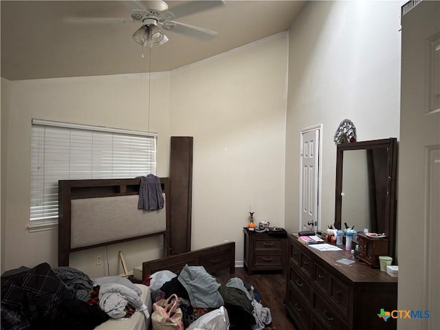 bedroom featuring dark wood-style flooring, baseboards, ceiling fan, and high vaulted ceiling