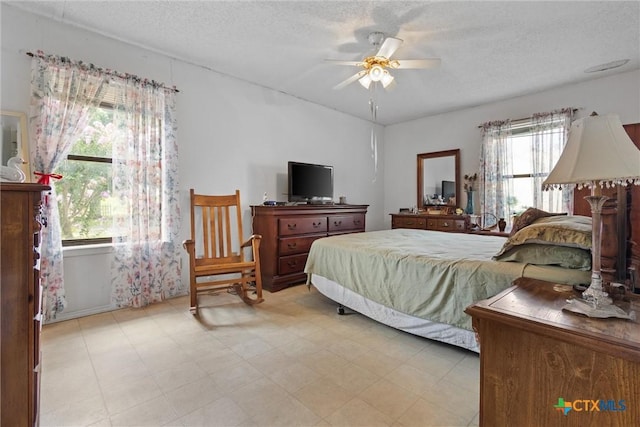 2080 Allison Rd, Martindale, TX 78655 - bedroom with a textured ceiling, a ceiling fan, and light floors