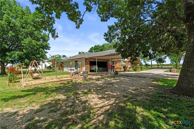 2080 Allison Rd, Martindale, TX 78655 - rear view of house featuring a playground and a yard