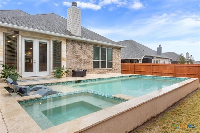 view of pool with an in ground hot tub and french doors