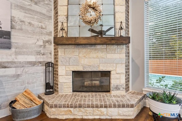 details with a stone fireplace and hardwood / wood-style floors