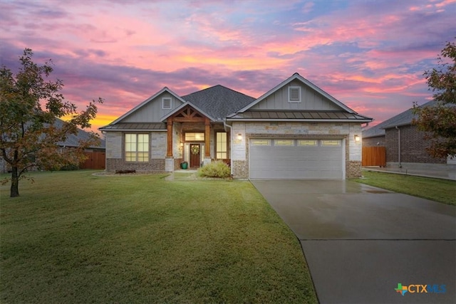 craftsman house with a garage and a lawn