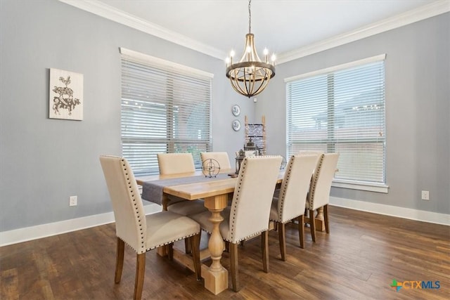 dining room with a chandelier, dark wood-type flooring, and ornamental molding