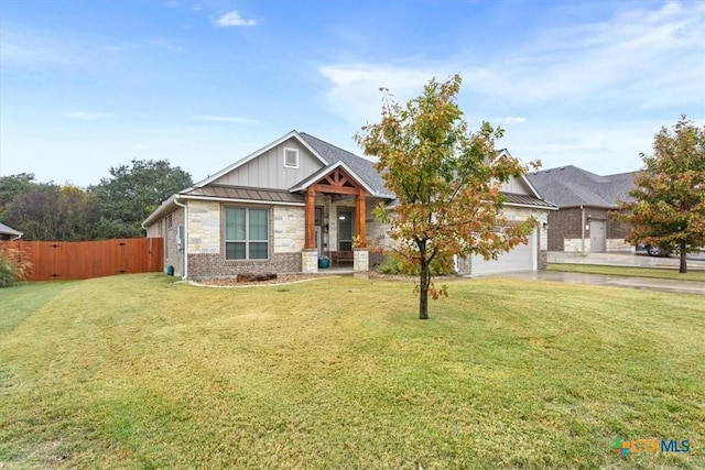 view of front of home featuring a front yard and a garage