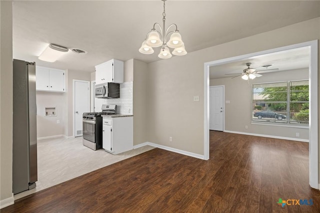 3102 Taft St, Killeen, TX 76543 - kitchen featuring appliances with stainless steel finishes, a chandelier, white cabinetry, dark wood finished floors, and baseboards