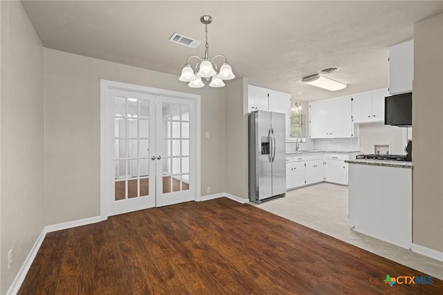 3102 Taft St, Killeen, TX 76543 - kitchen featuring stainless steel fridge, baseboards, french doors, a sink, and a chandelier