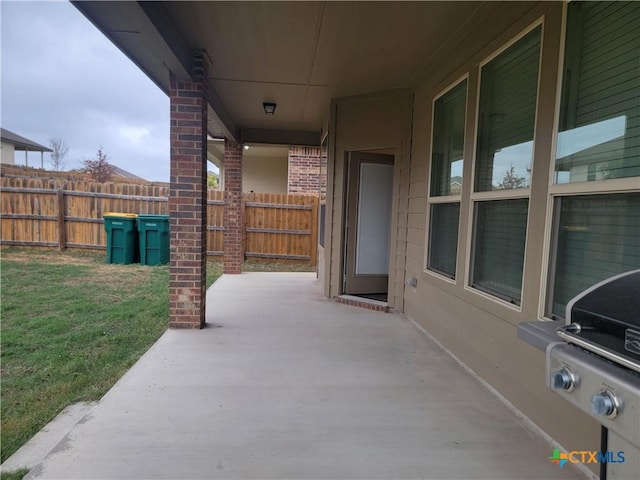 view of patio featuring grilling area and fence