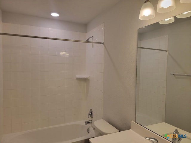 bathroom featuring vanity, toilet, and bathing tub / shower combination