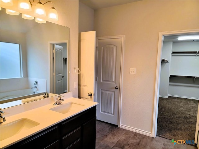 bathroom featuring double vanity, baseboards, and a sink