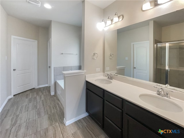 bathroom with vanity and independent shower and bath