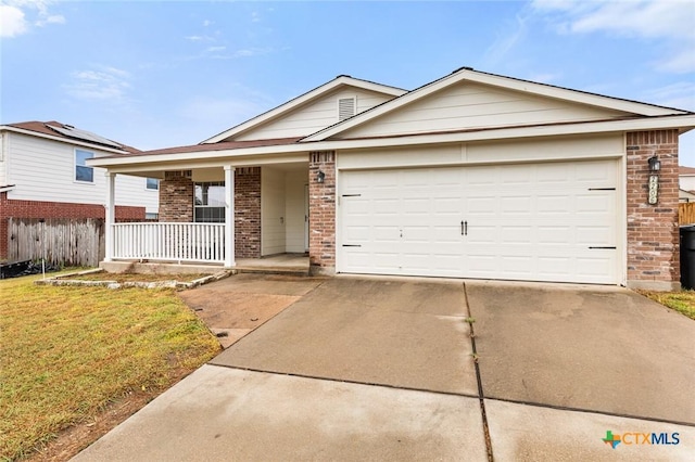 single story home with a garage, driveway, a porch, and brick siding