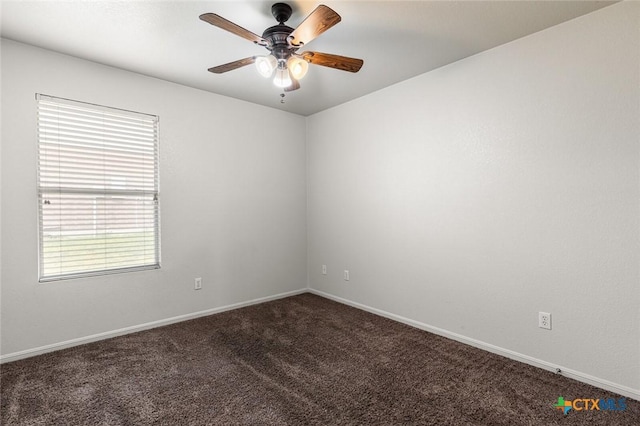 unfurnished room featuring ceiling fan, dark carpet, and baseboards