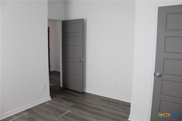 unfurnished room featuring dark hardwood / wood-style floors