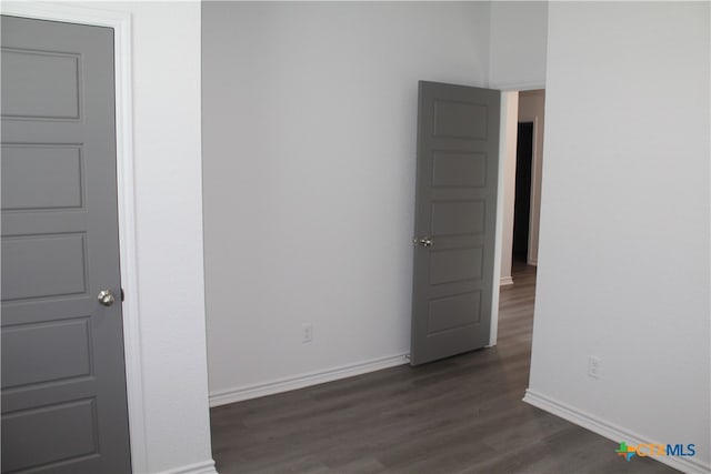 spare room featuring dark wood-type flooring