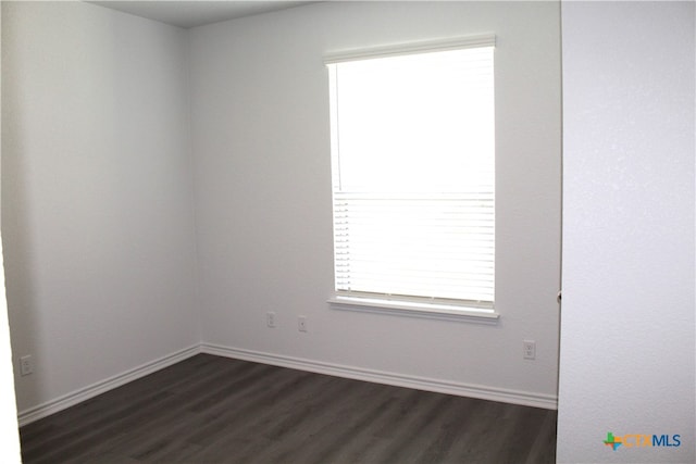 spare room with dark hardwood / wood-style floors