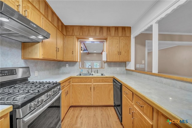 kitchen with a sink, gas range, dishwasher, light wood-style flooring, and under cabinet range hood