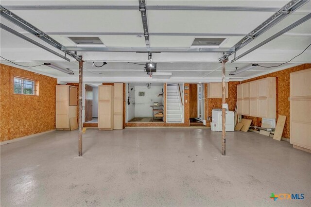 1009 E Robertson Ave, Copperas Cove, TX 76522 - garage featuring a garage door opener, washer / dryer, and wallpapered walls