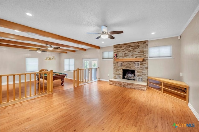 living room featuring billiards, wood finished floors, a ceiling fan, baseboards, and a textured ceiling