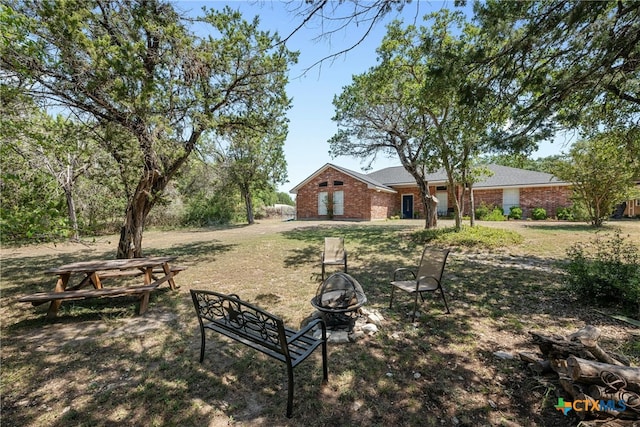 view of yard featuring an outdoor fire pit